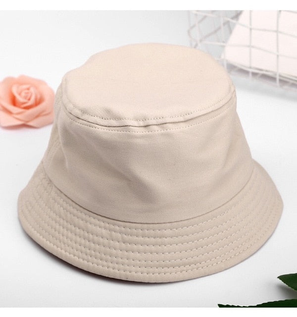 Beige Kids bucket hat angled view showing stitched brim and crown