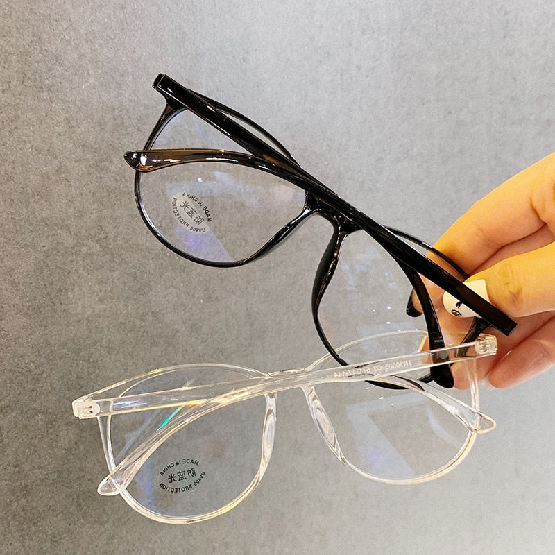 Black And Clear Blue light glasses held in hand stacked showing two frame colorways