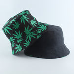Black And Green Bucket hat shown stacked revealing reversible leaf print and solid interior