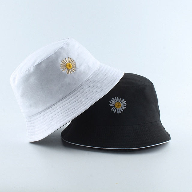 Black And White Bucket hat shown stacked in white and black colorways with daisy embroidery