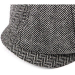 Black And White Newsboy cap flat lay close-up of herringbone brim and panel stitching