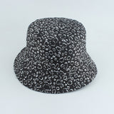 Black And White Bucket hat shown in angled view with allover leopard spot print