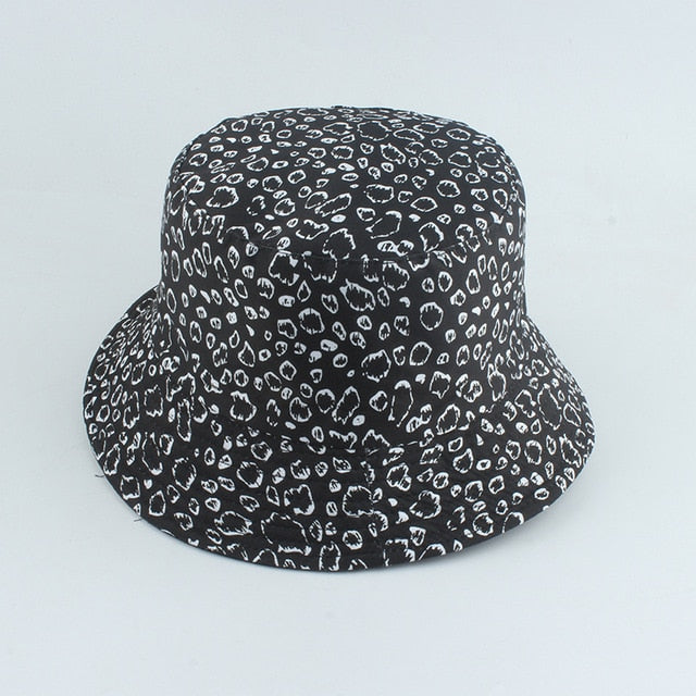 Black And White Bucket hat shown in angled view with allover leopard spot print