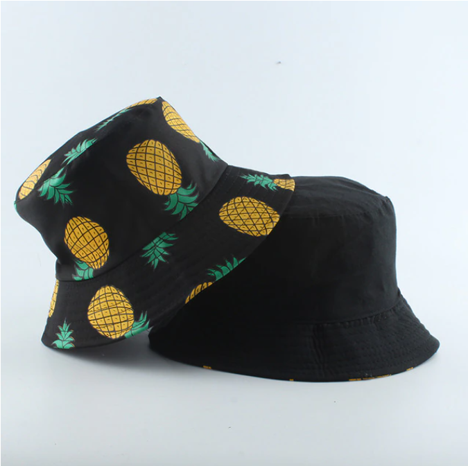 Black Bucket hat shown stacked revealing reversible pineapple print and solid interior