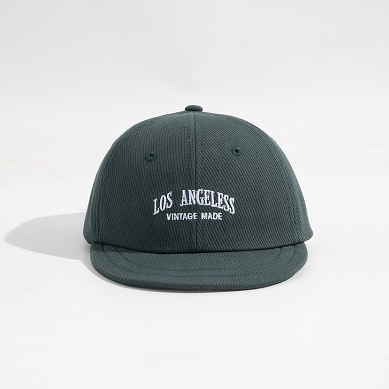 Dark Green Baseball cap front view flat lay showing embroidered logo and short brim