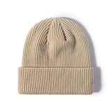 Khaki Knitted beanie hat flat lay on plain background highlighting ribbed knit pattern