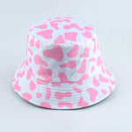 Pink And White Bucket hat shown in front view with allover cow print pattern